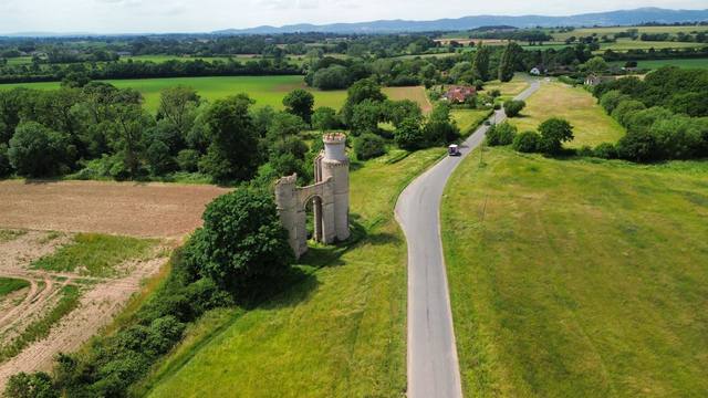 Aerial view of a rural gatehouse folly and surrounding farmland