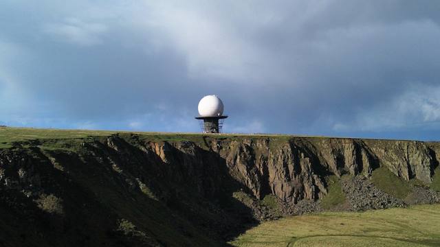 Aerial view of a radar station on a cliff top