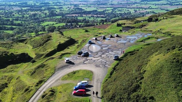 Aerial view of a hilltop site access road and car park