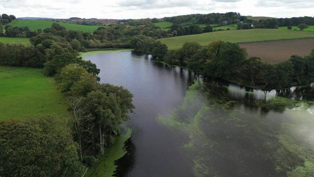 Aerial view of a river winding through farmland